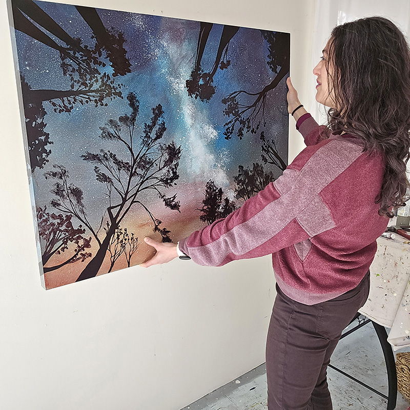 Artist Cedar Lee with cosmic painting