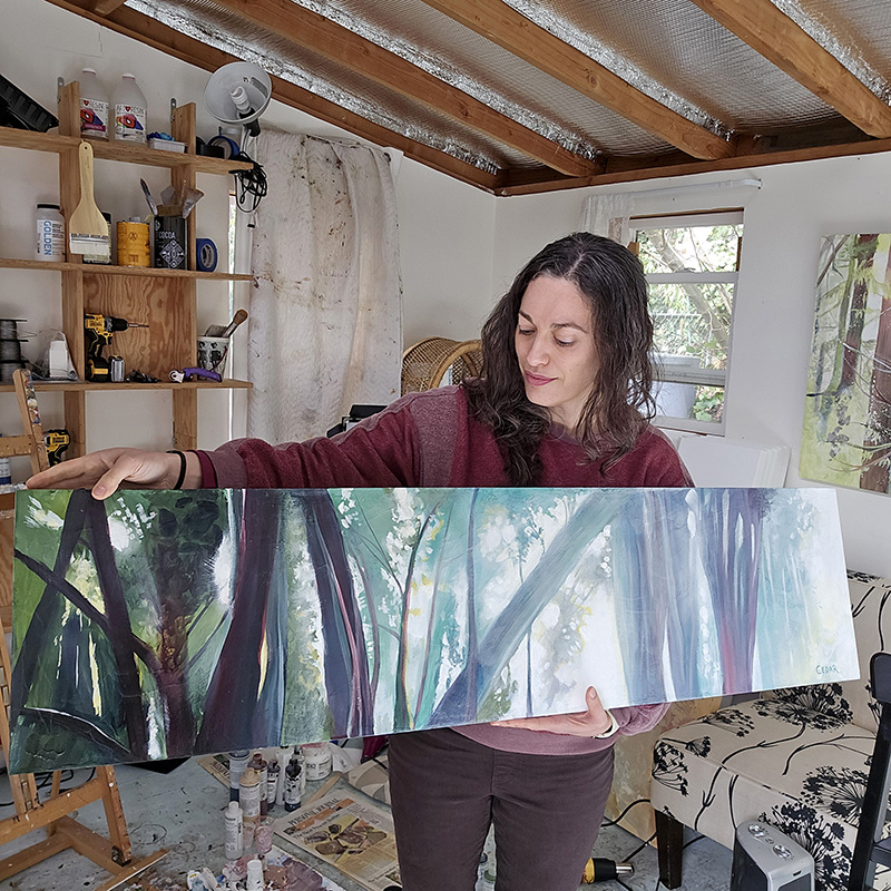 Cedar Lee in studio with jungle painting