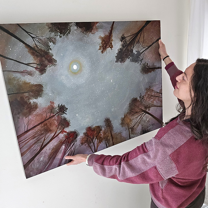 Cedar Lee in painting studio with her art